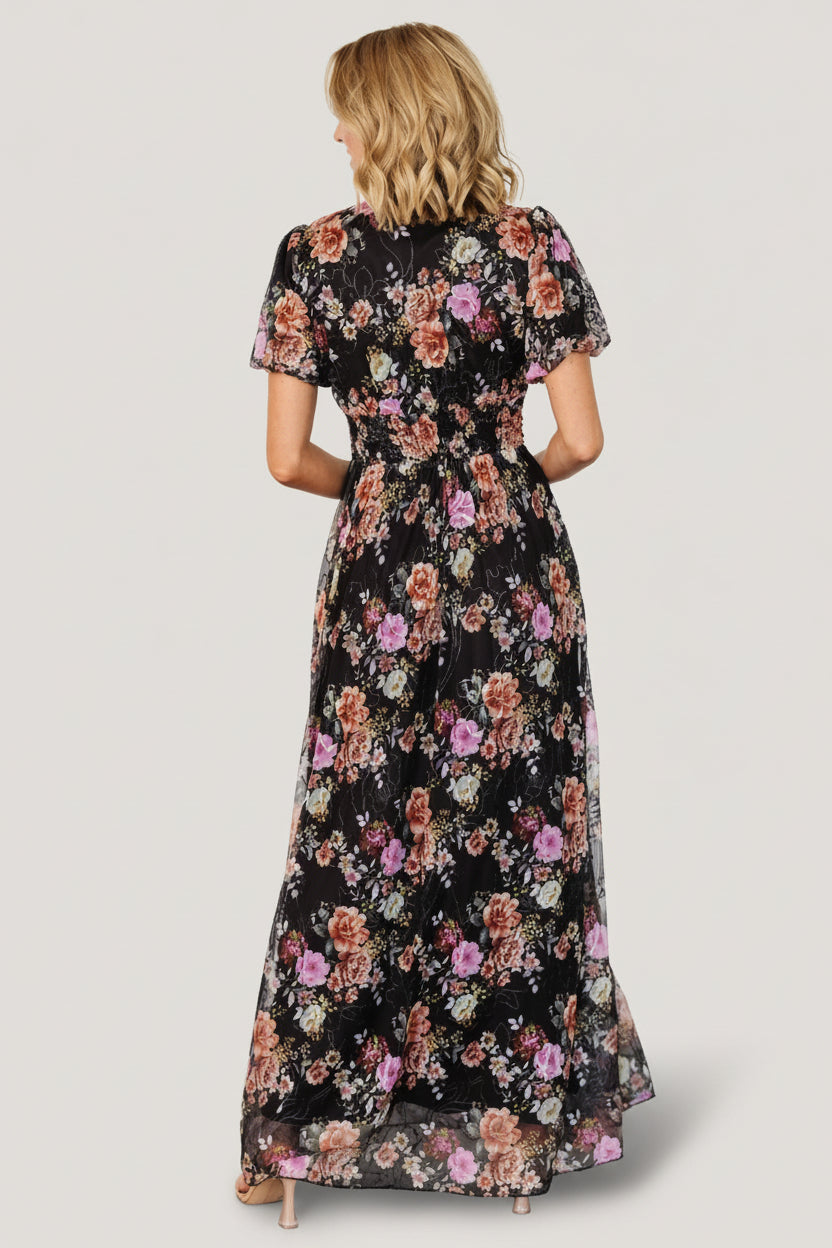 Back view of Ardley Maxi Dress in black multi floral showing skirt drape, length and embroidered textured detail across the fabric.
