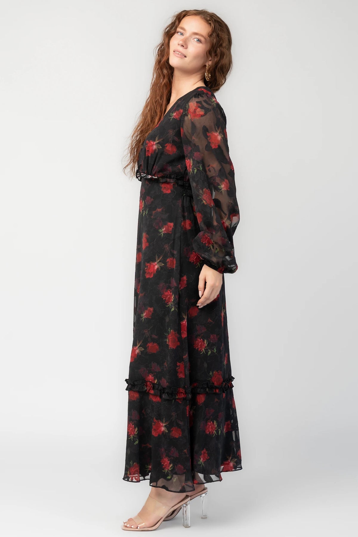 Avalora Midi Dress in Black Rose Floral with V-neckline, sheer long sleeves, smocked waist, and ruffle tier.