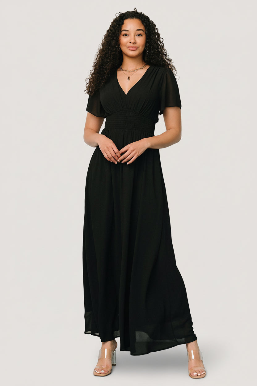 Close-up of the Birdie Maxi Dress bodice in black, highlighting V-neckline, smocked waist detail, and lightweight chiffon texture.