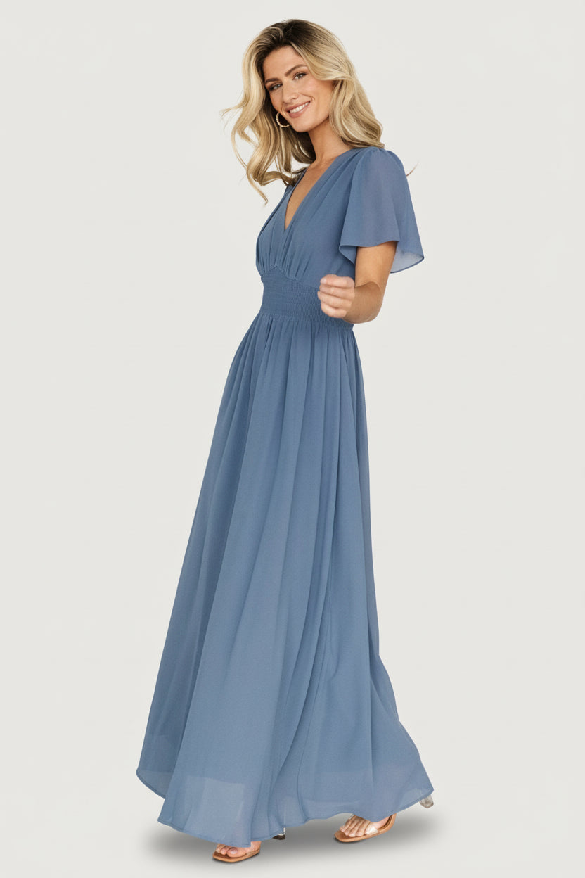 Styled flat-lay and close fabric detail of the Birdie Maxi Dress in Whisper Blue highlighting lightweight chiffon and stitched hems.