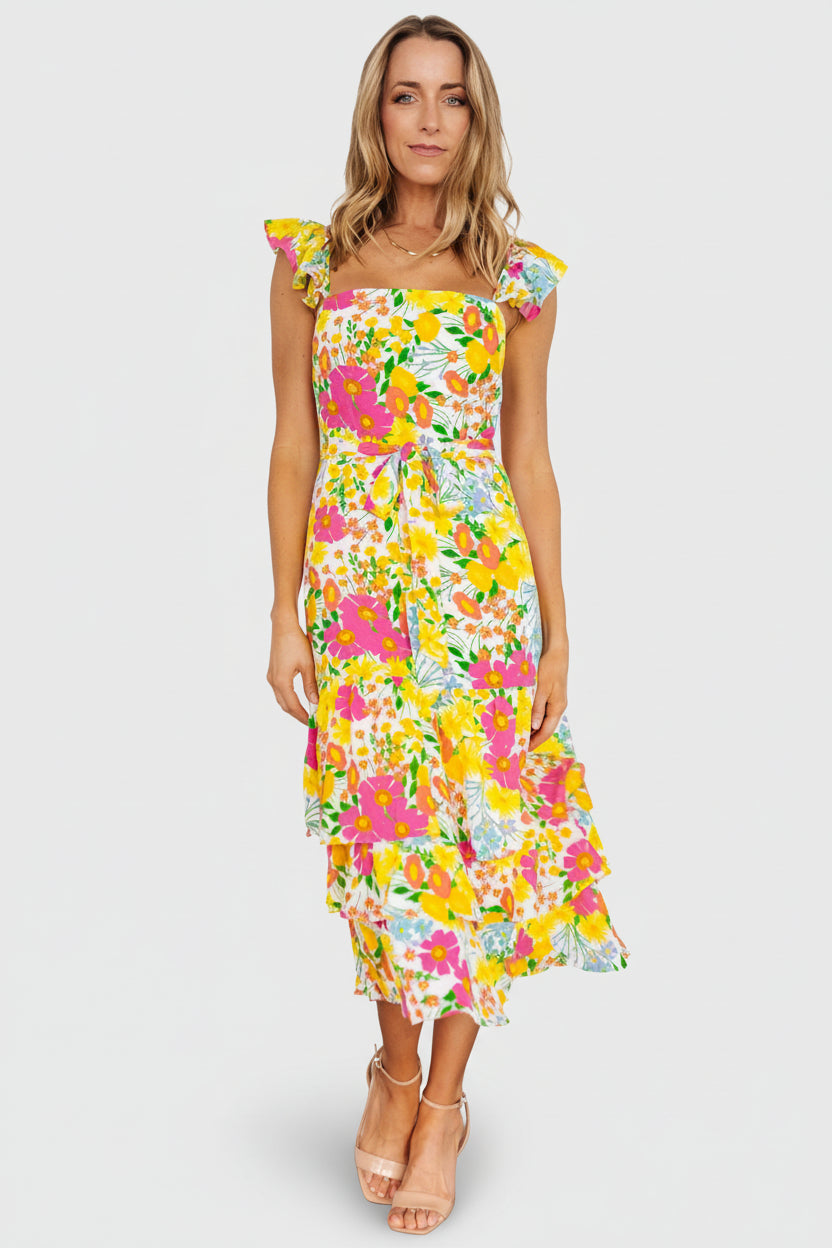 Styled look of the floral midi dress with natural movement in the skirt tiers, ideal for daytime and resort occasions.