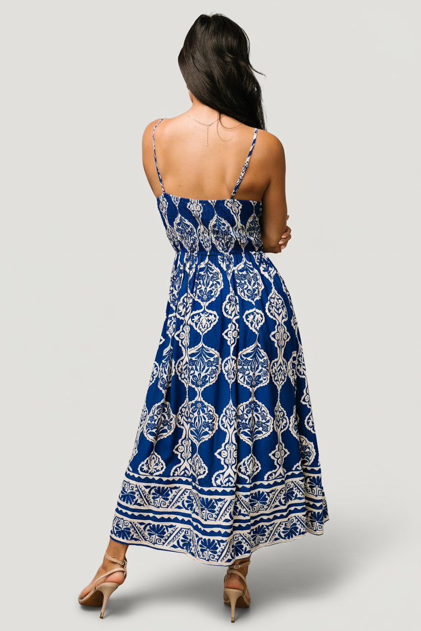 Close-up of fabric pattern and texture on the Delia Midi Dress, showing the rich blue background and cream print in rayon weave.