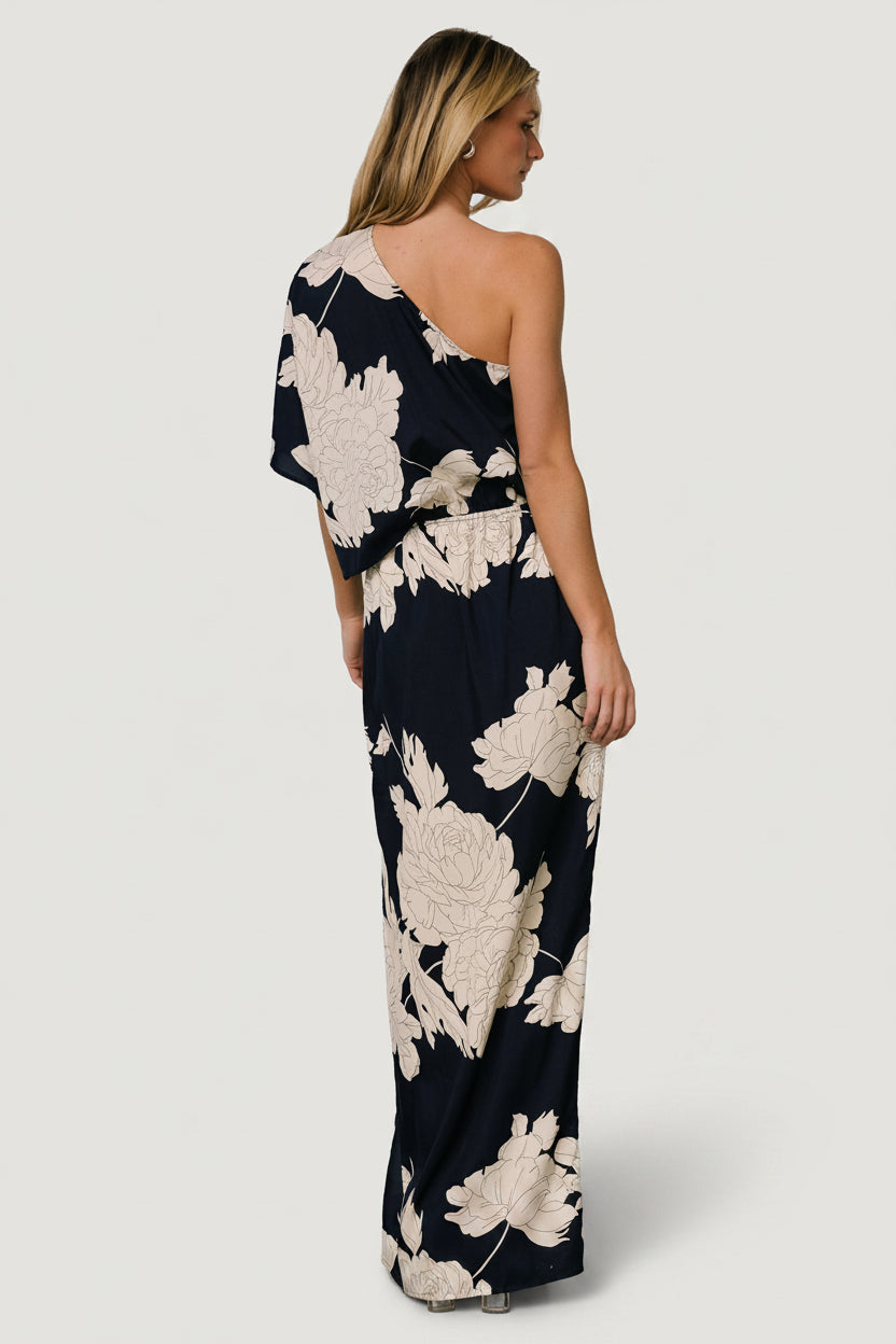 Styled flat-lay and drape detail of the navy-and-cream fabric, showing print placement and soft polyester texture for evening wear.