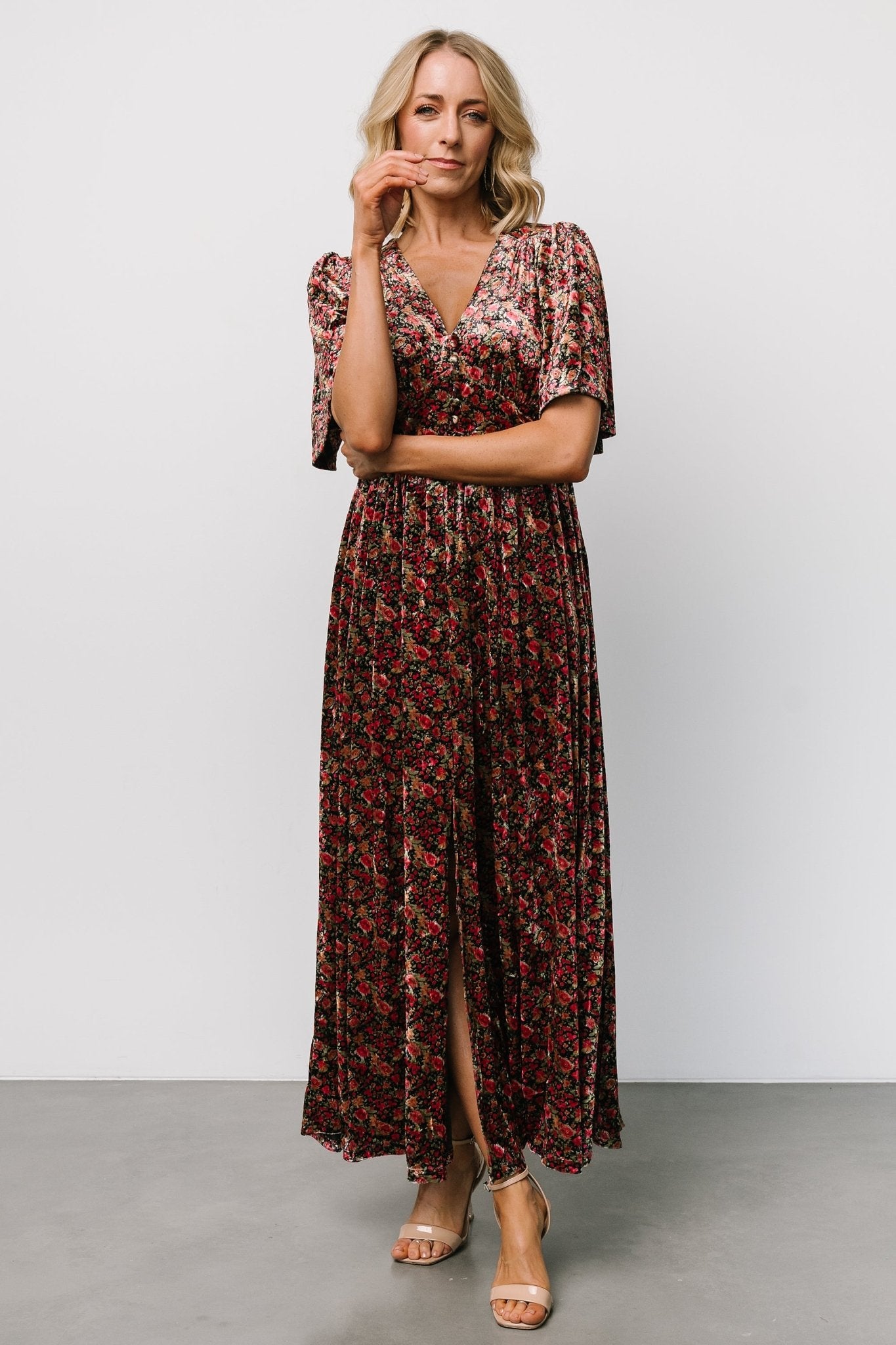 Detail of the left-leg slit and partially lined skirt on the Irina Velvet Maxi Dress in black multi floral, illustrating movement.