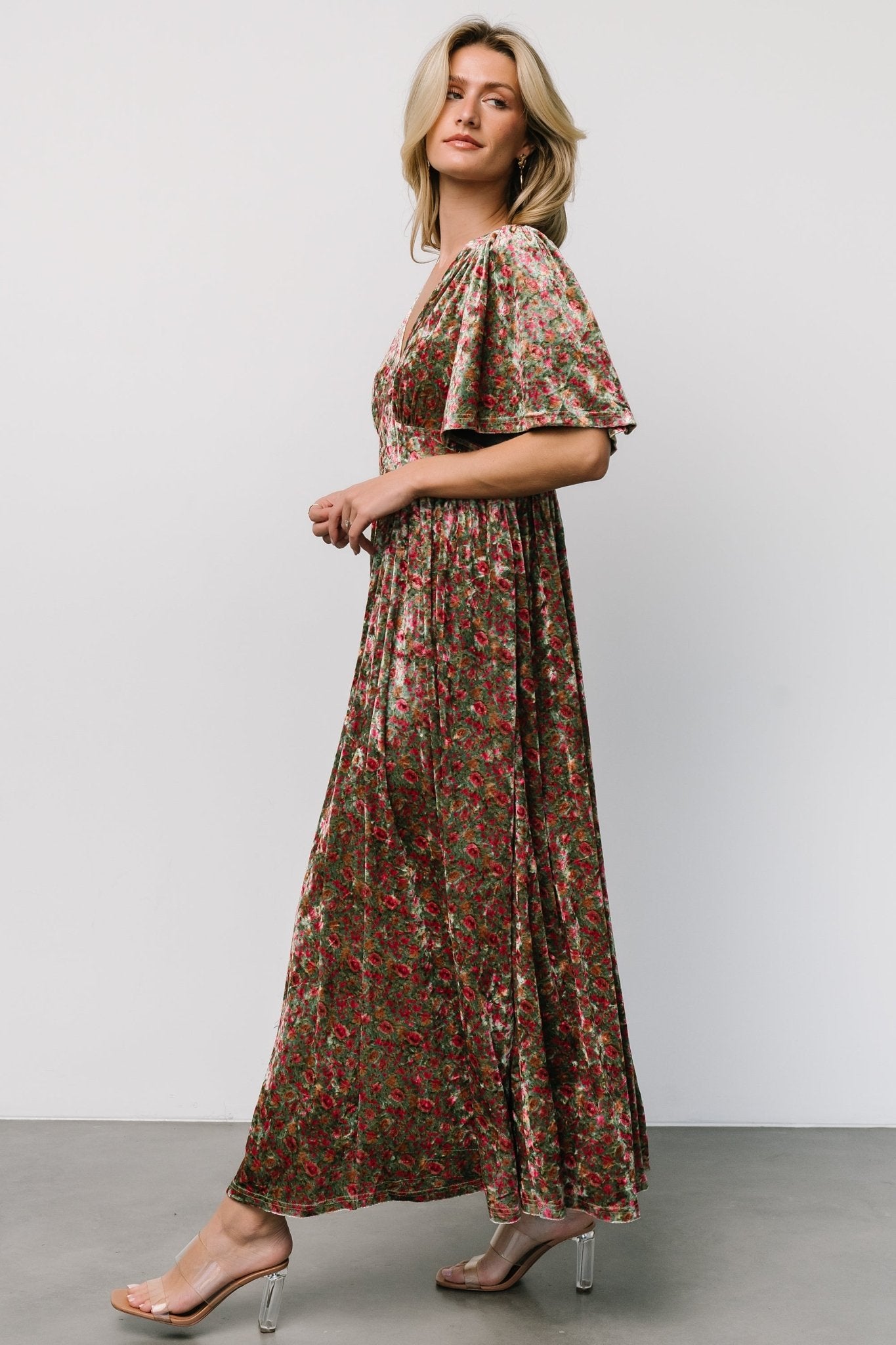 Back view highlighting the smocked empire waist and relaxed straight fit through the body, showing how the dress shapes the silhouette comfortably.