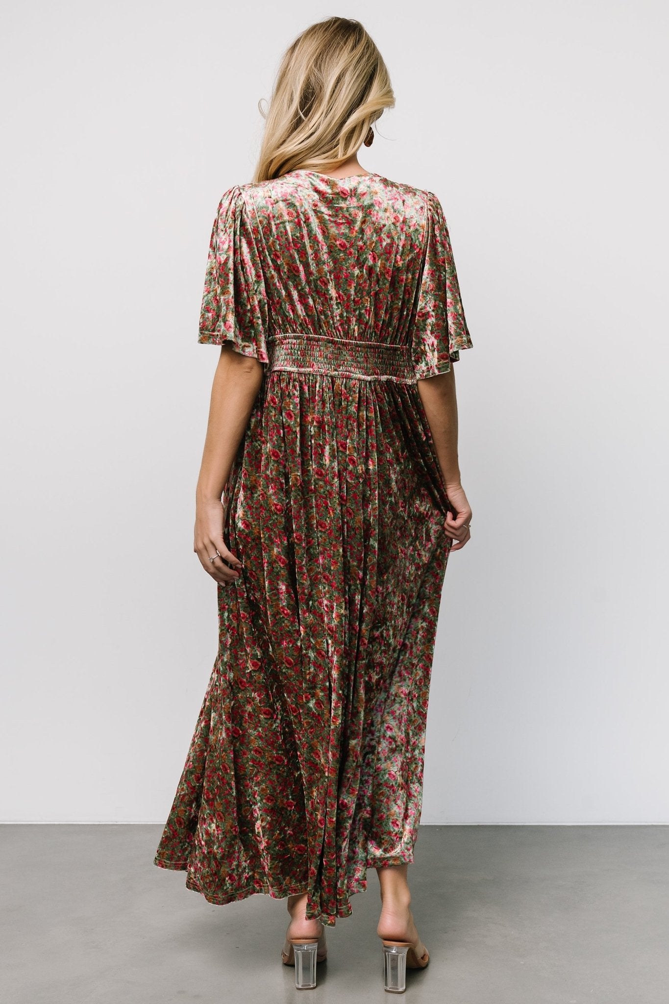 Side view focusing on the hidden left-side zipper and left leg slit, illustrating ease of movement and the dress's flowing maxi skirt.