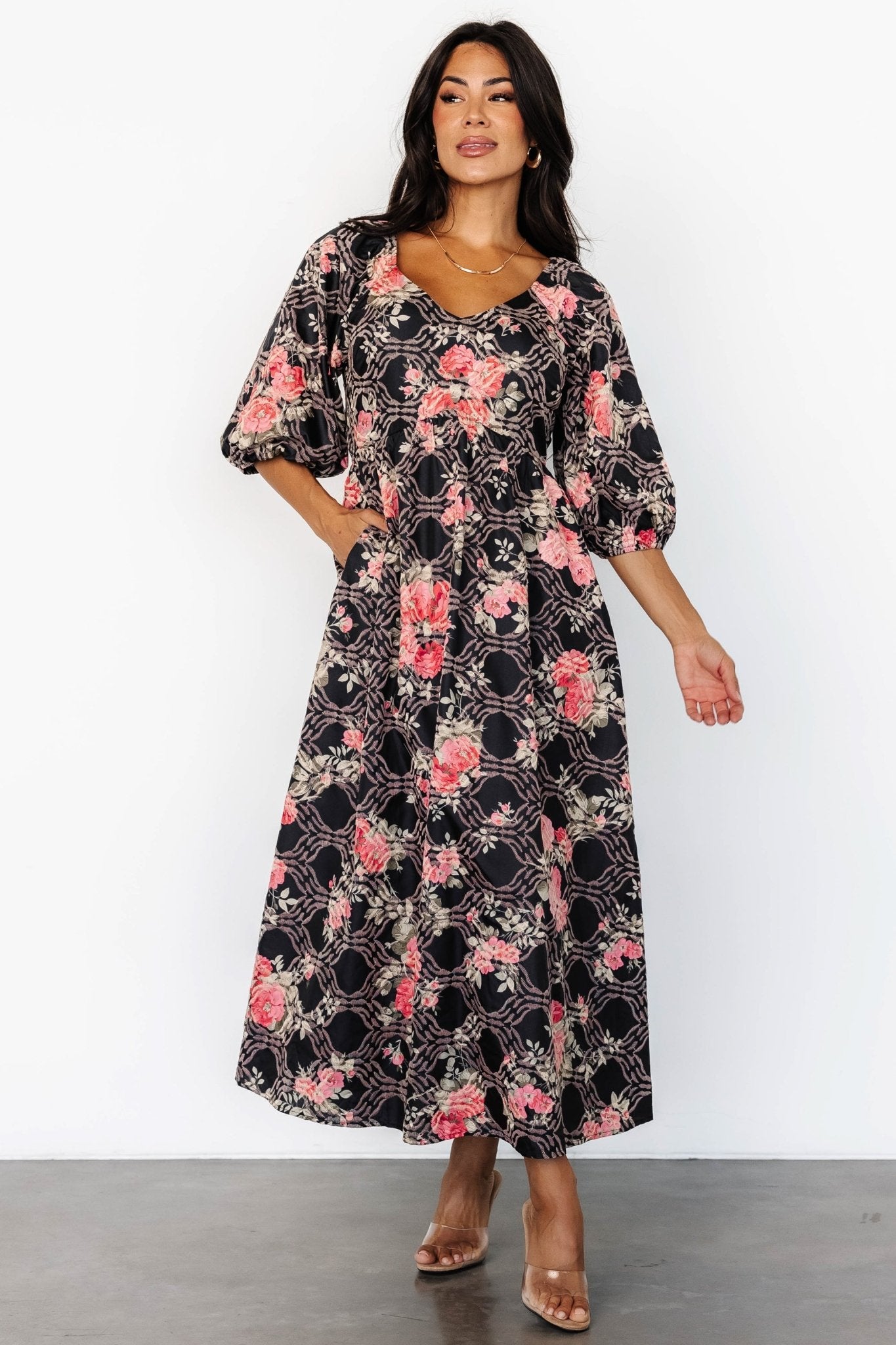 Model wearing Ivanna Embroidered Satin Midi Dress: midi length, high upturned-V waist and flowing skirt in motion.