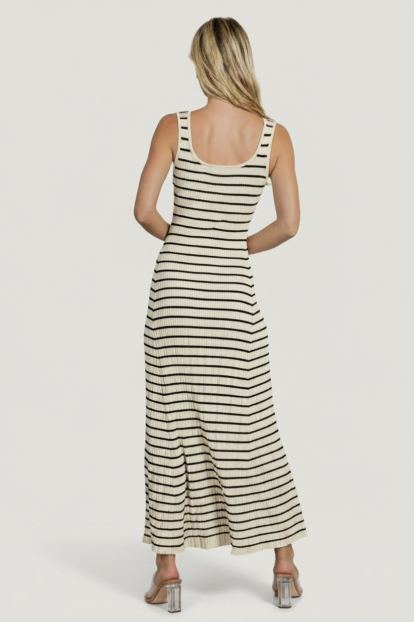 Styled shot of Jesse maxi dress in warm ivory with black stripe, paired with casual sandals for a daytime look.