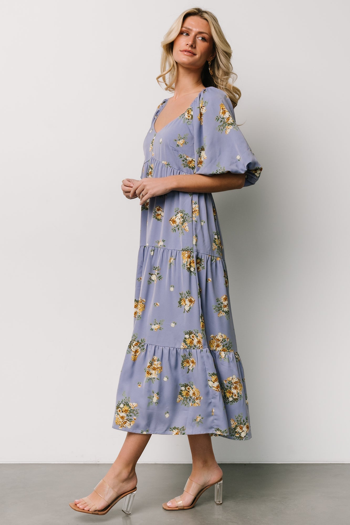 Close-up detail of chiffon fabric and golden floral print on Judith dress, showing fabric darts at the bodice and print scale.