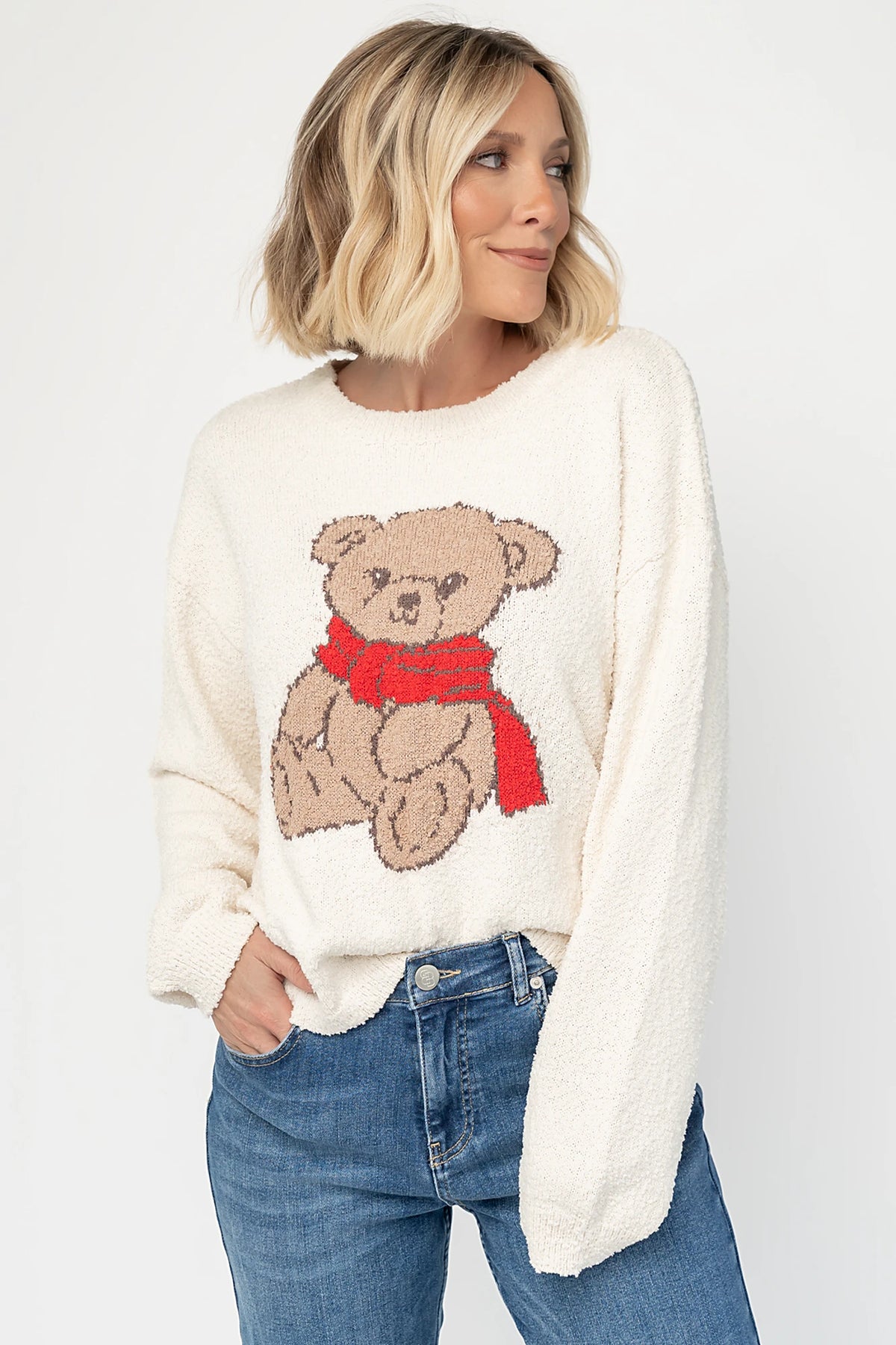 Junie Cozy Bear Sweater in Ivory with teddy bear graphic, red scarf, crew neckline, and ribbed trim.