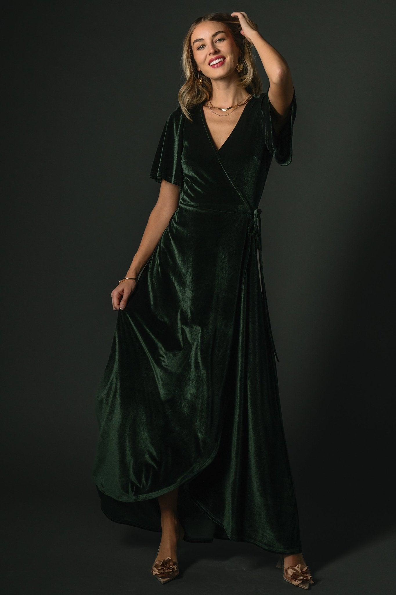 Close-up of deep green velvet fabric and texture, showing subtle sheen and slight stretch of the material.