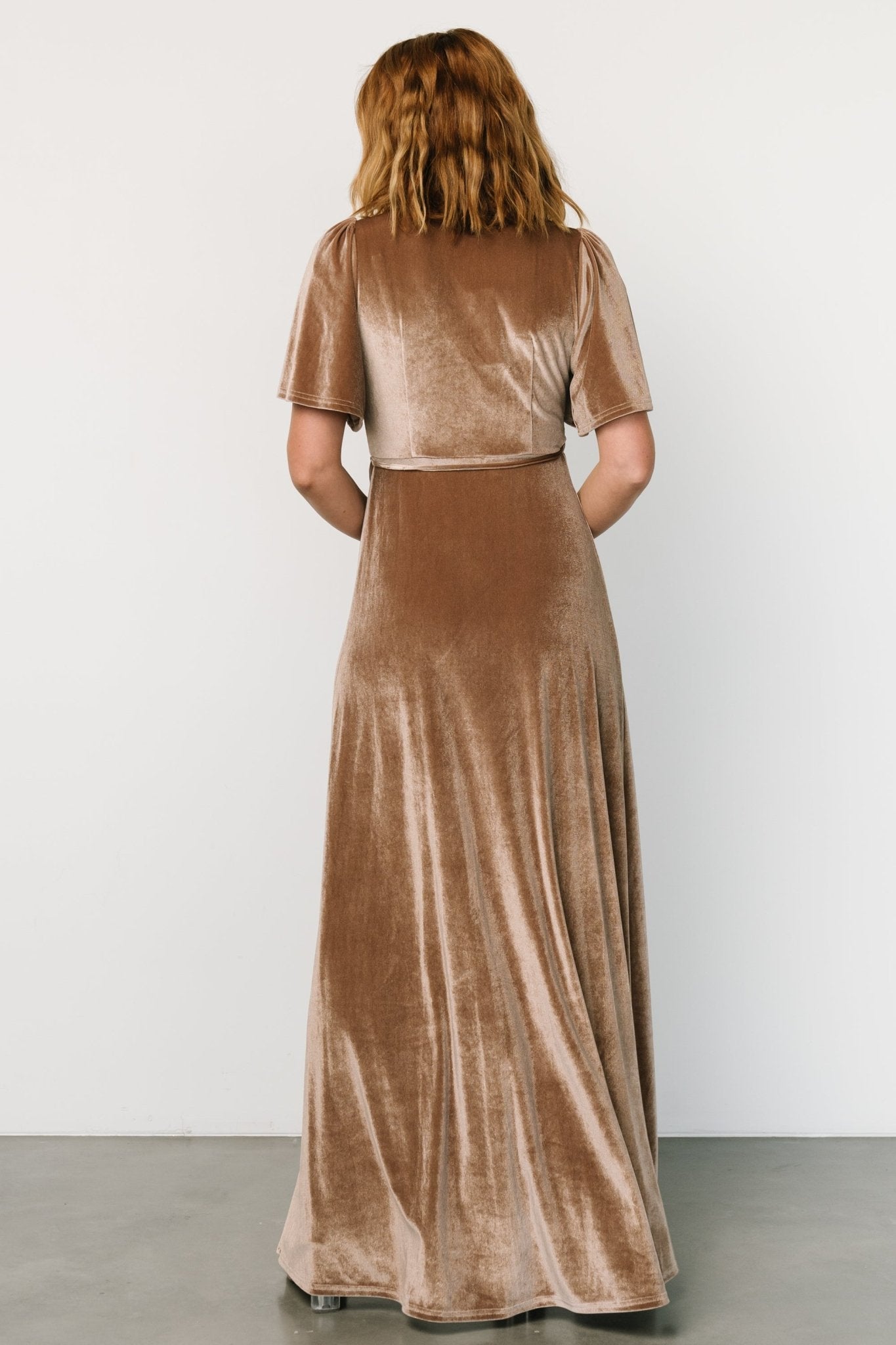 Back view of Katelyn Velvet Maxi Wrap Dress in taupe, showing full lining, back drape, and how the waist ties sit when tied.