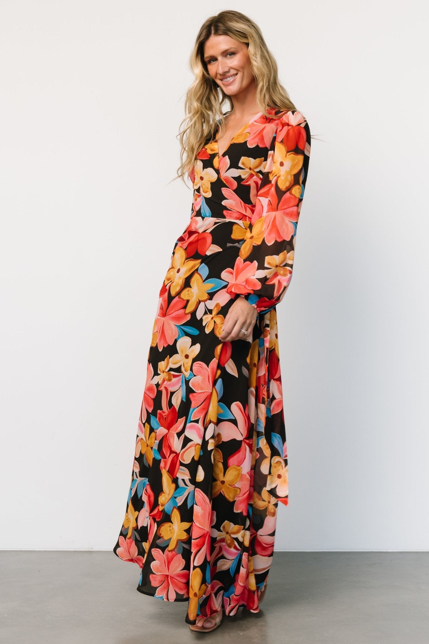 Model wearing Katinka Wrap Maxi Dress in Tropical Night Floral, showing fit on the body and the dress's occasion-ready style.