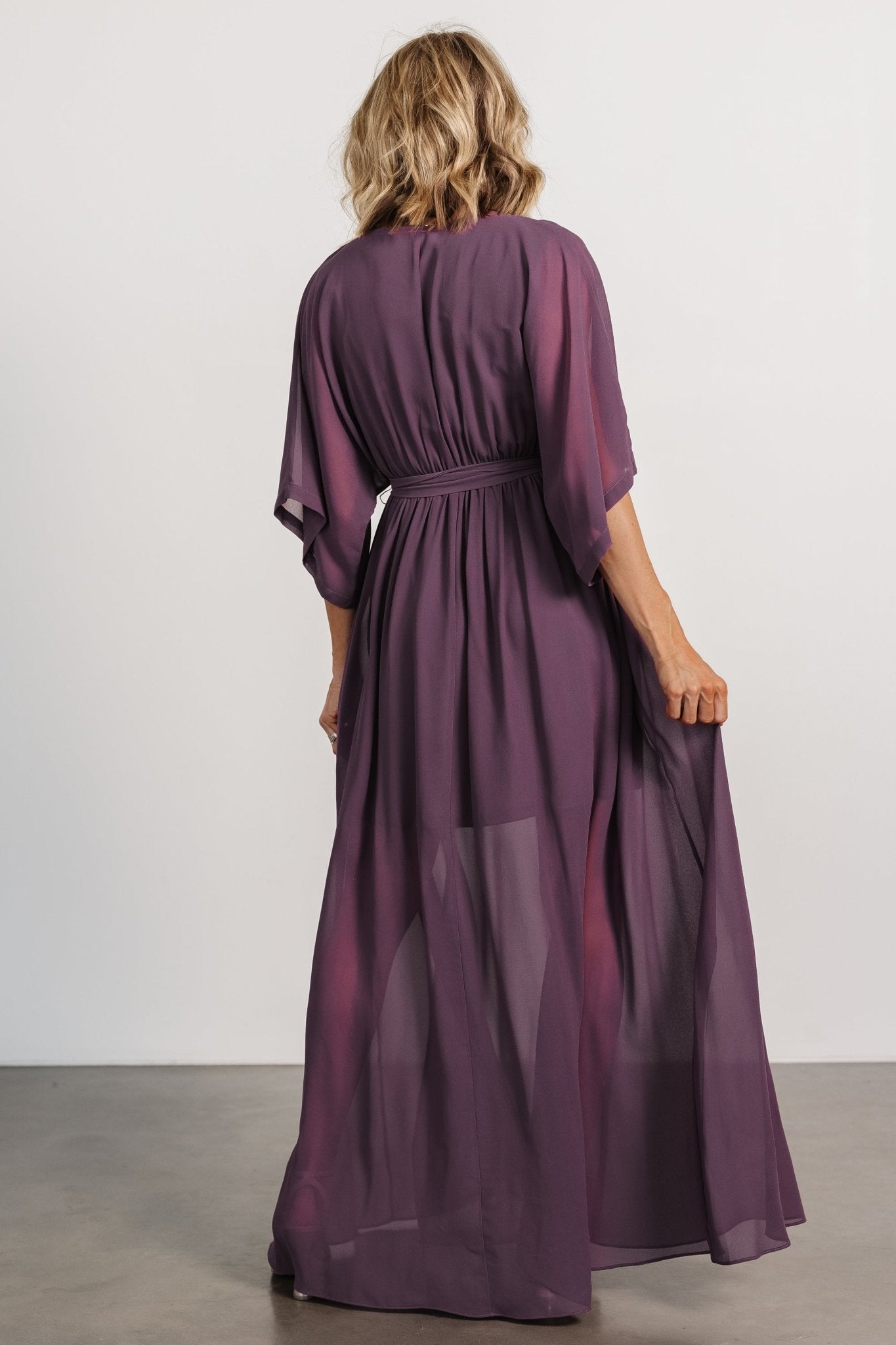 Back view of the Kia Kimono Maxi Dress in vintage plum showing the relaxed kimono sleeves, gathered elastic waist, and long flowing hem.