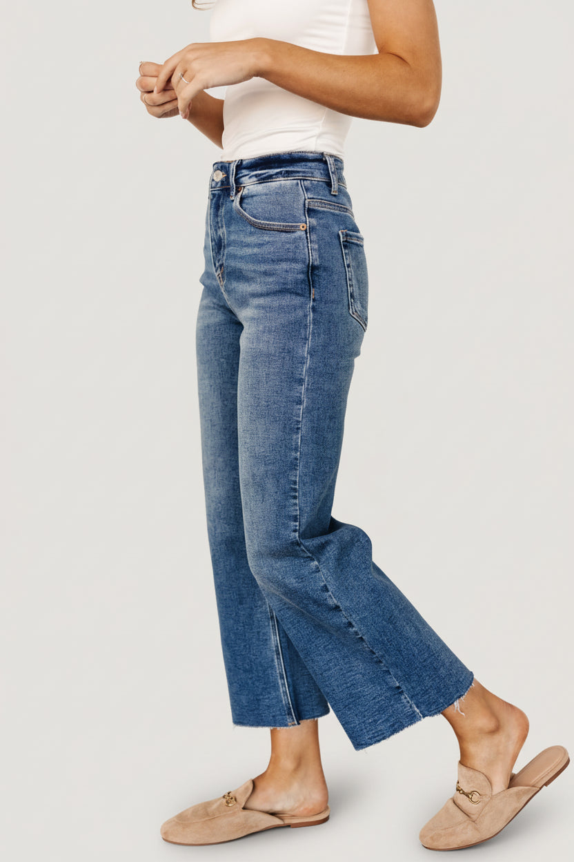 Lifestyle image of Kirby high-rise wide-leg jeans worn with a casual top, highlighting stretch denim and easy movement.