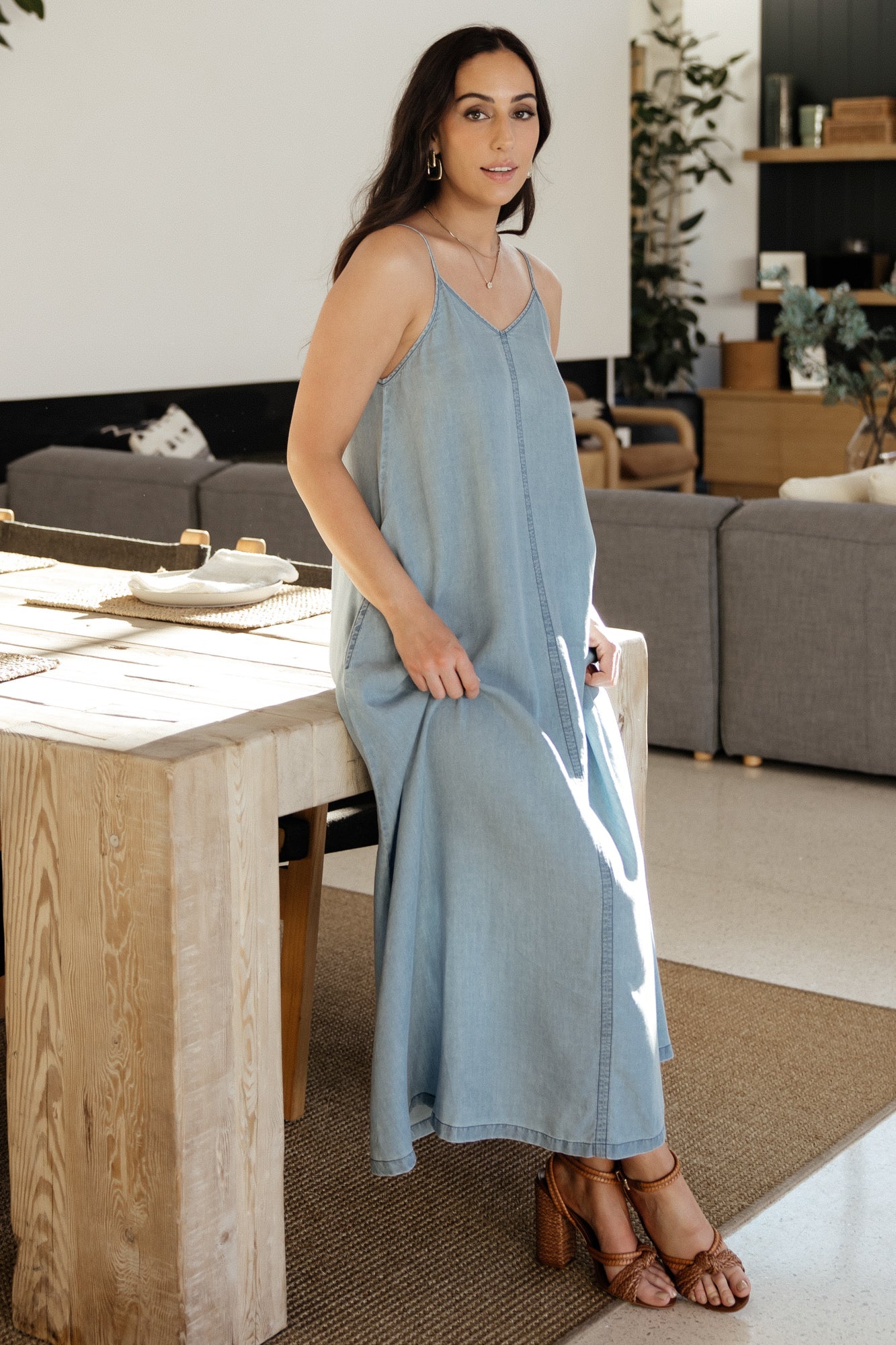 Side view of Kyla Maxi Dress in medium denim wash on model, highlighting the straight fit, unlined skirt and natural drape.