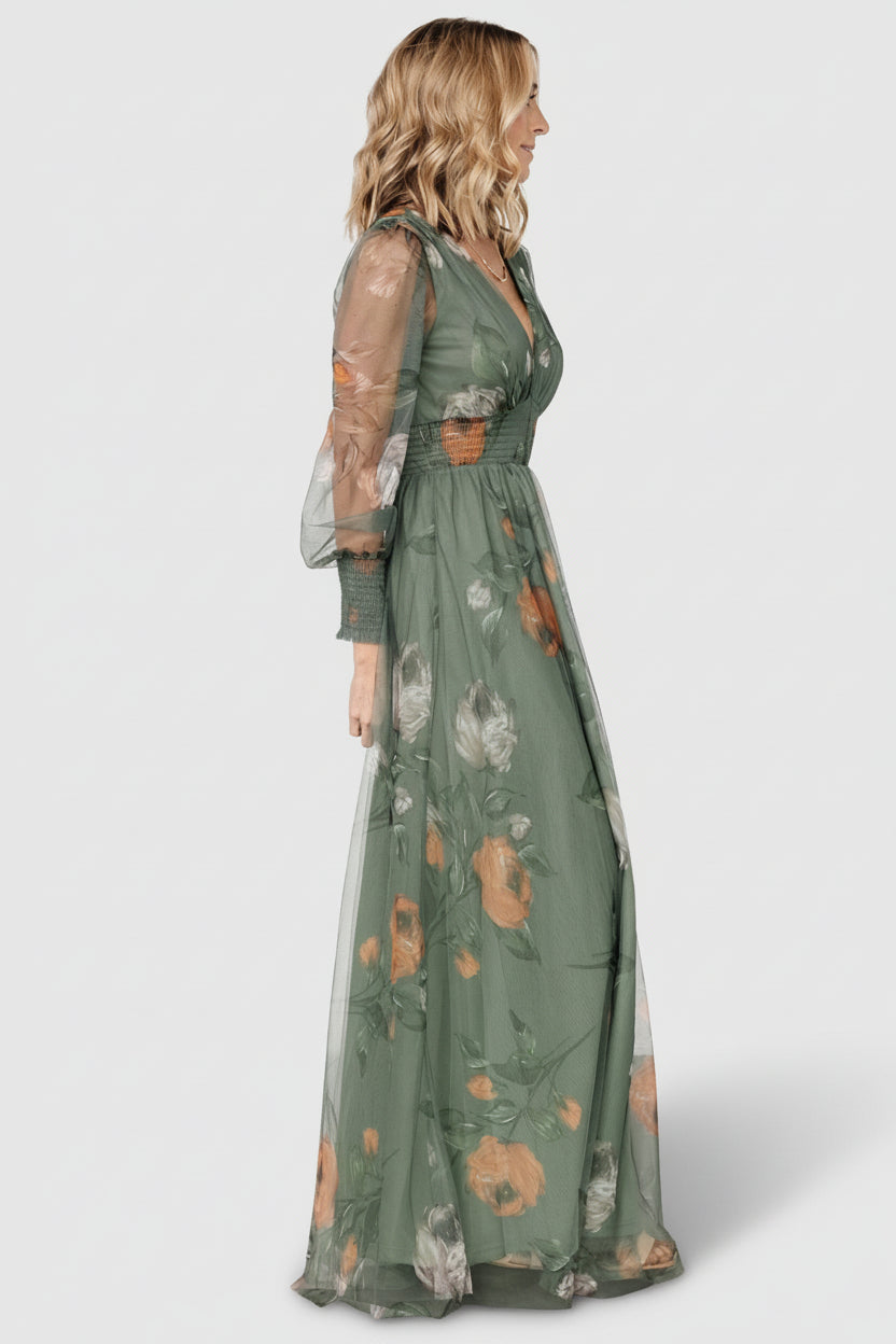 Model movement shot in Layla Tulle Maxi Dress dusty olive floral, emphasizing flowing tulle skirt, deep V-neck and bump-friendly silhouette.