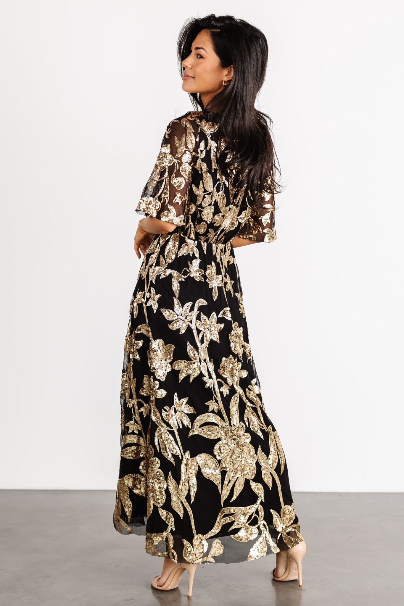 Studio image of Lucy Sequin Dress on model, showing fit at the waist, round neckline, and overall evening-appropriate styling.
