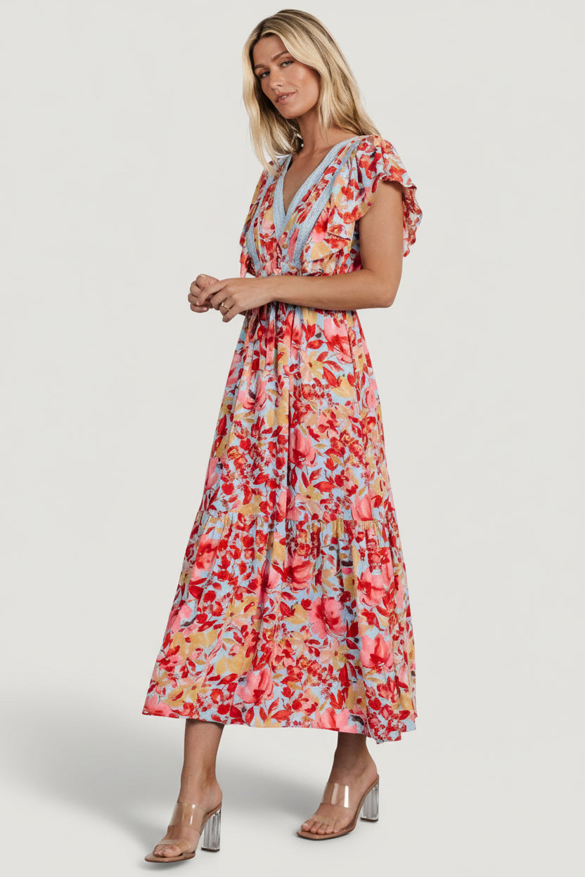 Styled look of Maggie Maxi Dress worn with neutral sandals; showcases the dress's floral print, lace details, and relaxed boho silhouette.