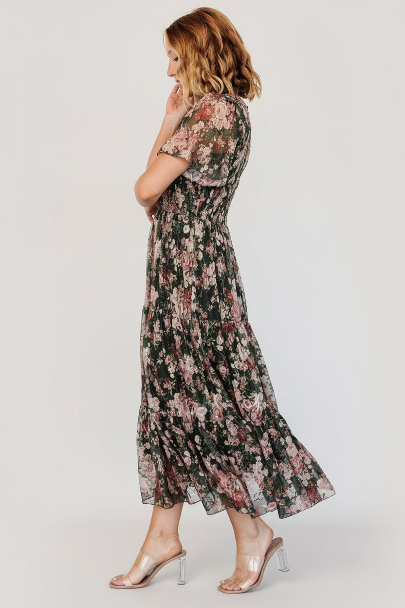 Side view highlighting the three-tier midi skirt and soft tulle drape, showing embroidered floral pattern and movement.