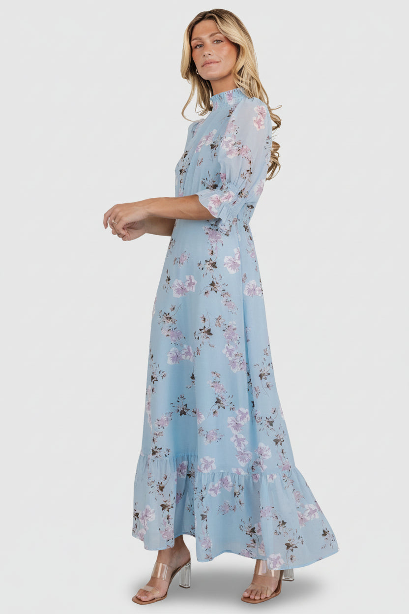 Model wearing Marie Mock Neck Maxi Dress in sky-blue floral chiffon, showing overall length, sleeve fit, and how the skirt moves while walking.