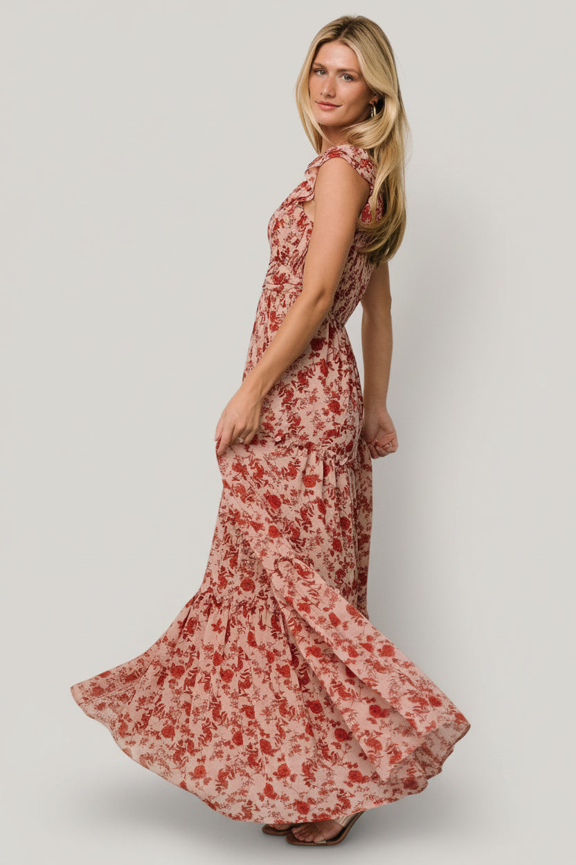 Back view of Martina Maxi Dress displaying smocked back bodice, elastic shoulder with ruffle, and tiered maxi skirt movement.