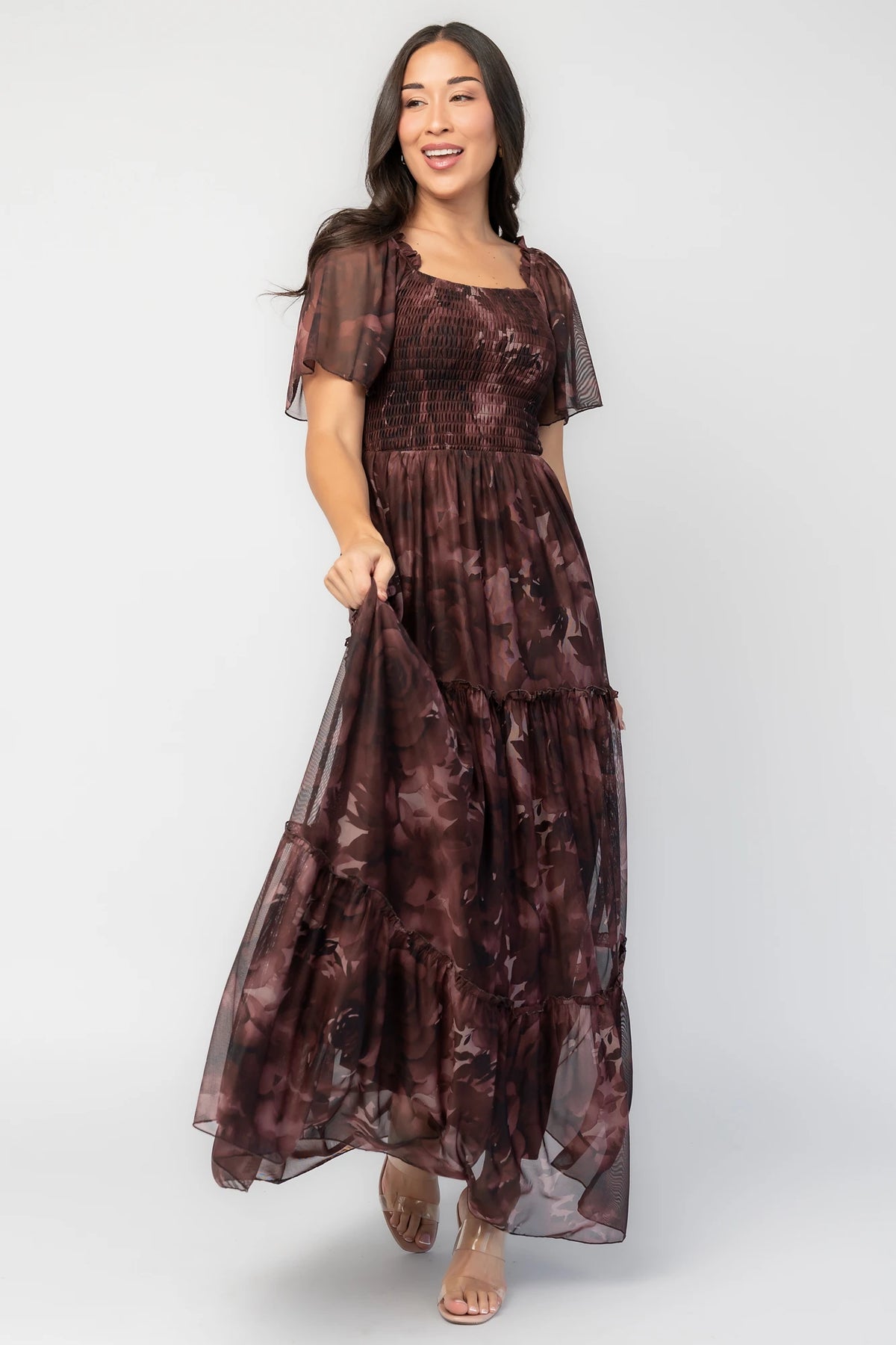 Meya Mesh Maxi Dress in Dark Mahogany Print with abstract florals, smocked bodice, flutter sleeves, and tiered skirt.
