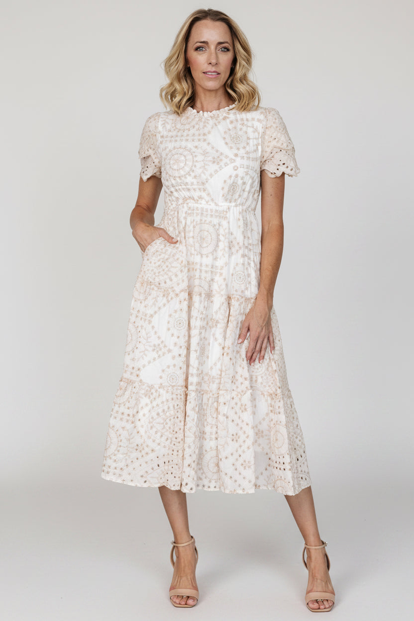 Side view of the midi dress showing the elastic waistband, tiered silhouette, and the placement of the hidden side pocket on the skirt.