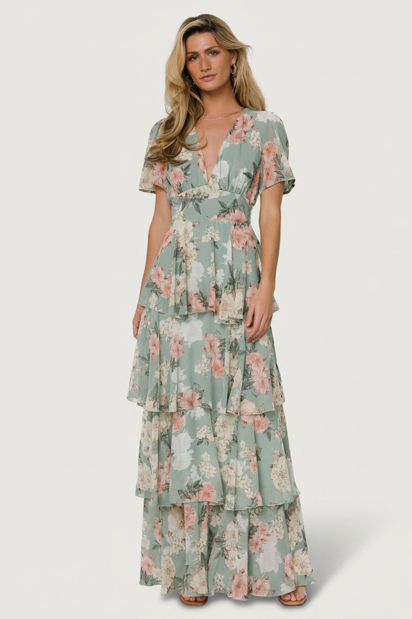 Styled outdoor shot of the Montaigne ruffle maxi dress in dusty sage floral, showcasing silhouette, ruffle detail and fabric movement.