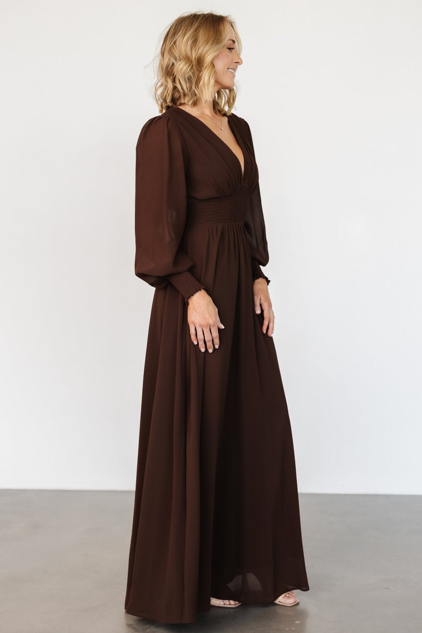Detail shot of Olivia dress sleeve with smocked cuff and sheer chiffon fabric in deep espresso brown.