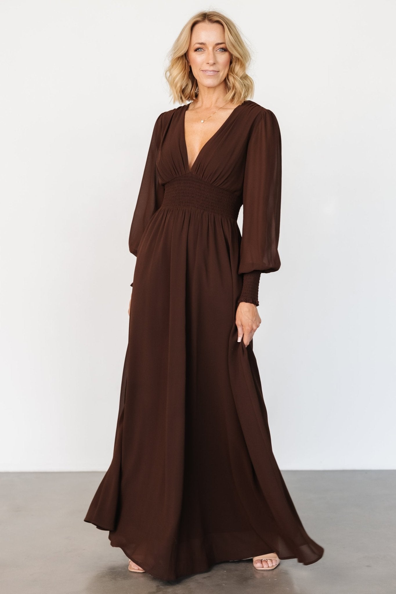 Three-quarter view of Olivia maxi in deep espresso brown, highlighting flowing chiffon skirt and lined bodice on model.