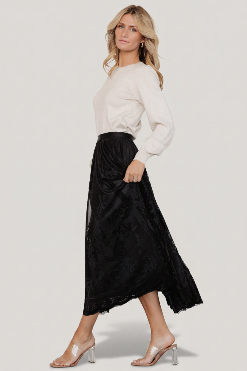 Back and side view of the Palini Velvet Skirt in black, showing the full lining, elastic waistband, and midi-length silhouette on model.