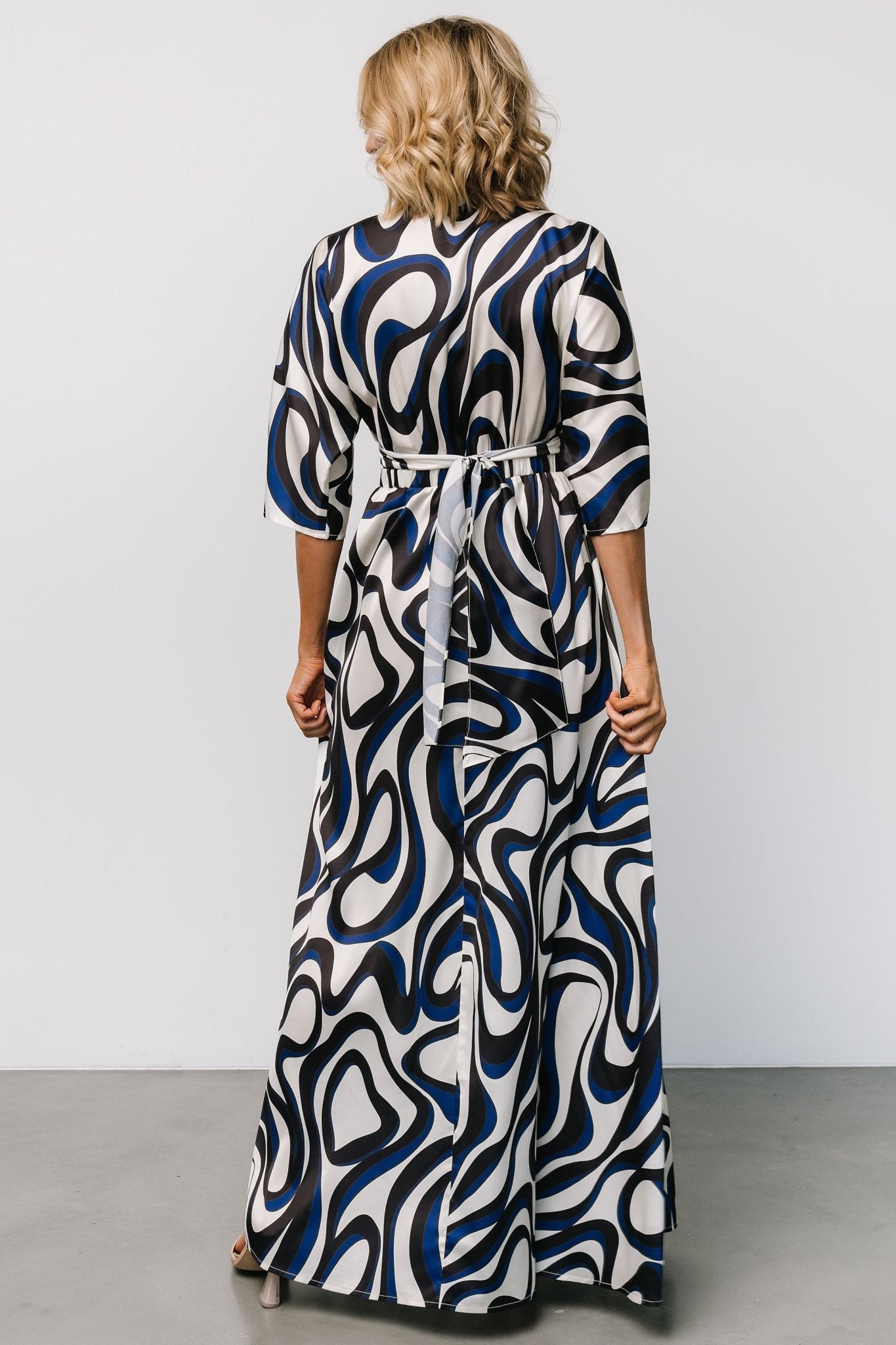 Close-up of the ivory multi print and silky satin texture with visible subtle sheen and navy-blue patterning detail.