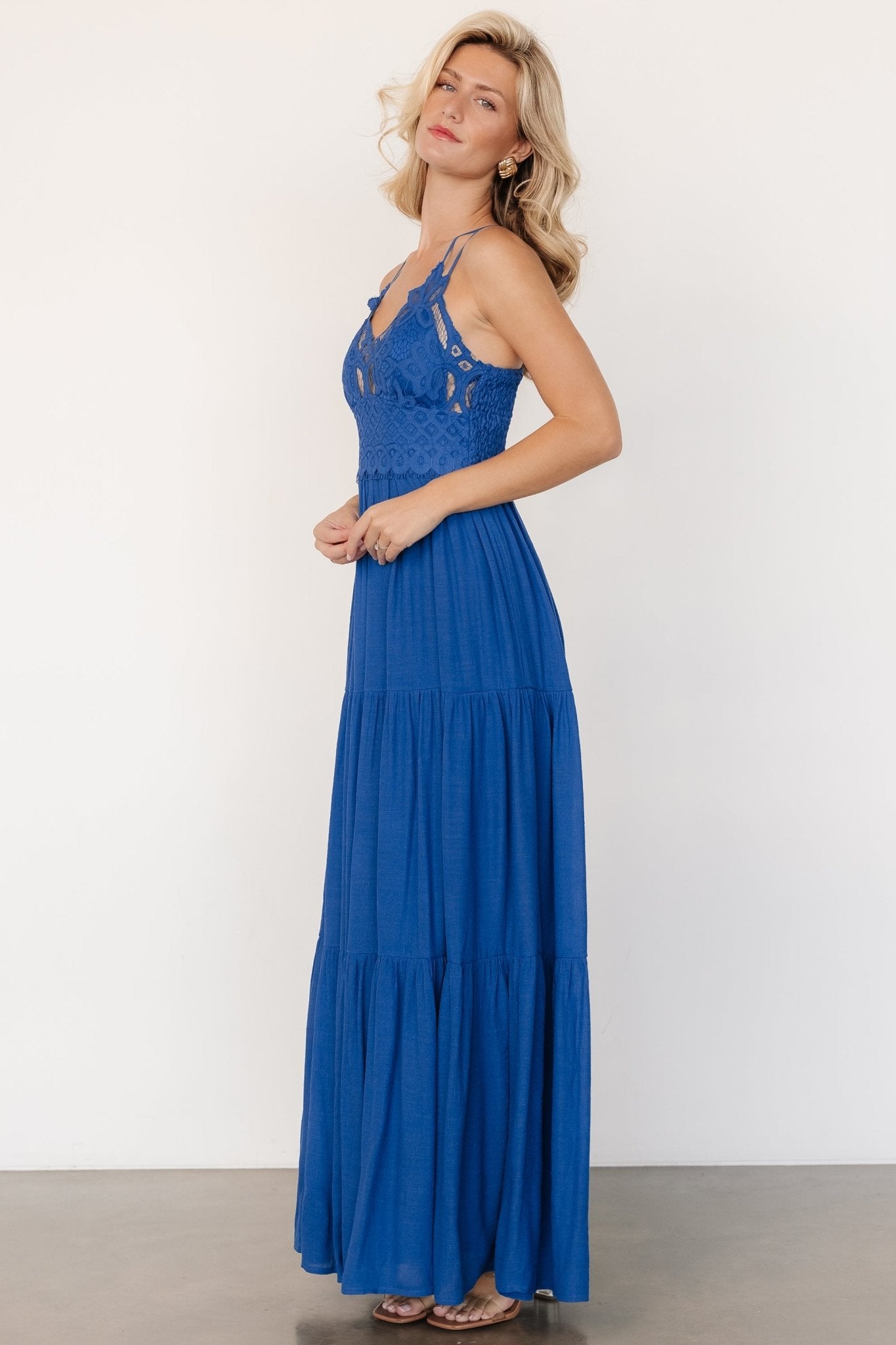 Movement shot of blue Summerlin Lace Top Maxi Dress showing tiered skirt and lightweight lining in motion.