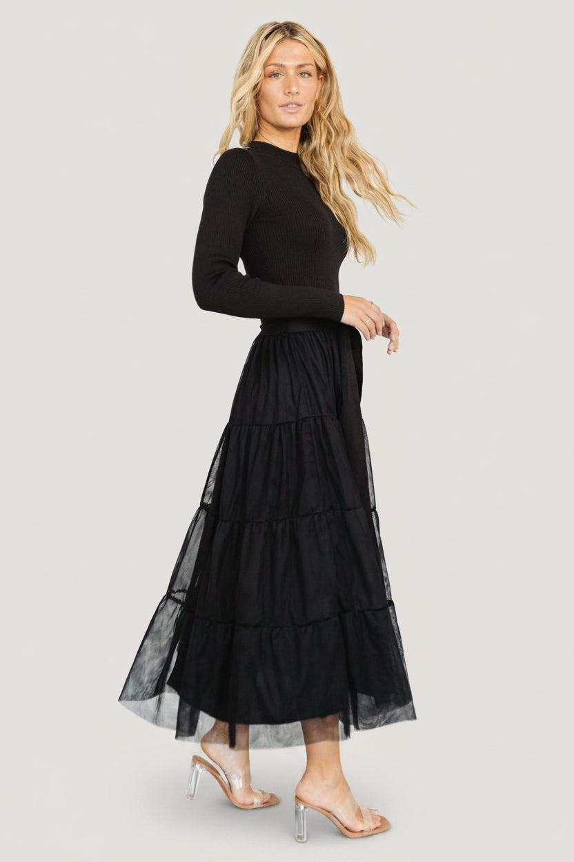 Styled outfit shot of the black demi sweater tulle dress paired with minimal accessories to showcase versatility.