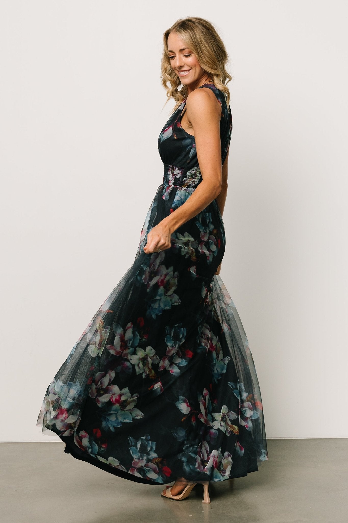 Fabric close-up showing navy abstract floral print on tulle overlay with the soft, lightweight texture of the dress material.