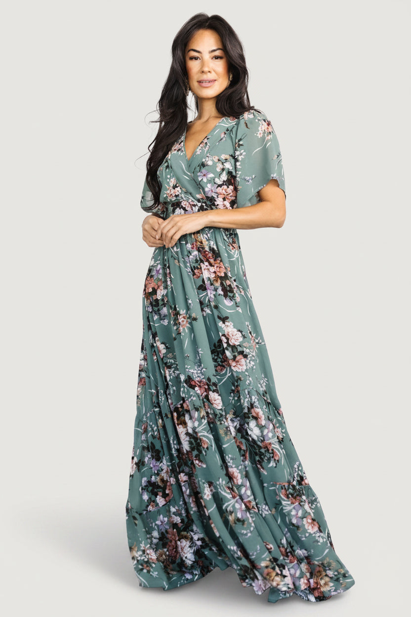 Full-length image of Katherine Maxi Dress in dusty green floral on model demonstrating length, tiered skirt panels, and lightweight chiffon silhouette.