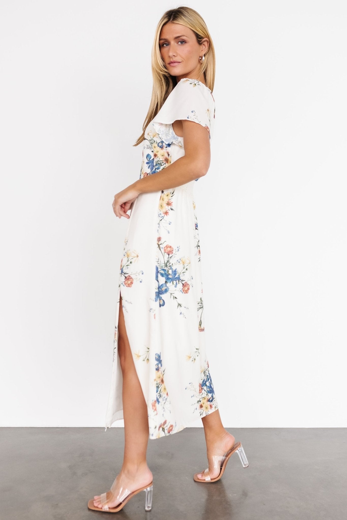 Back view of Kirsten Midi Dress in cream floral chiffon, showing smocked waistband and keyhole with button closure at the nape.
