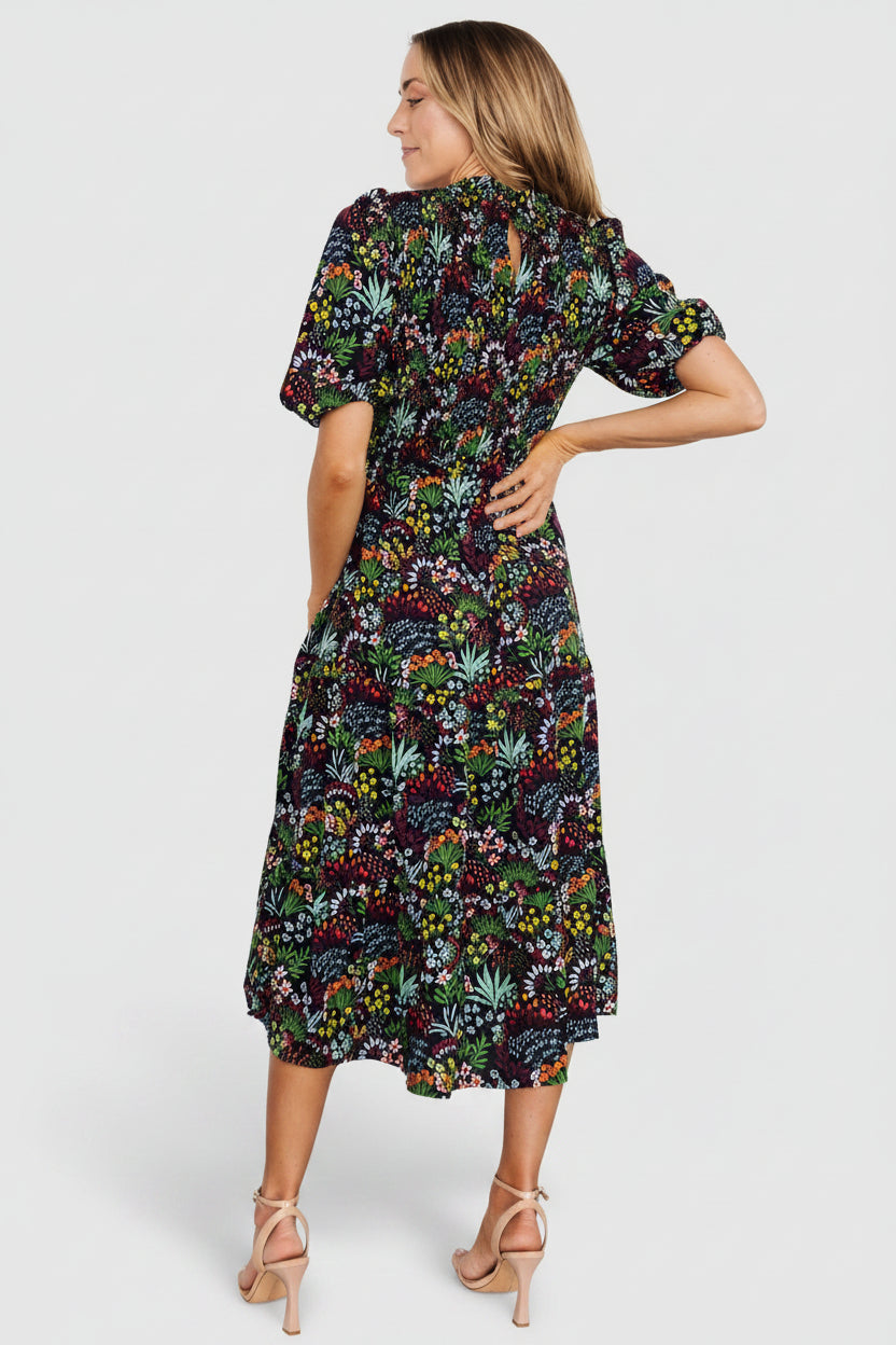 Detail shot of high ruffle neckline and back keyhole with button closure on Lena Tiered Midi Dress in black multi floral, showing finishing details.