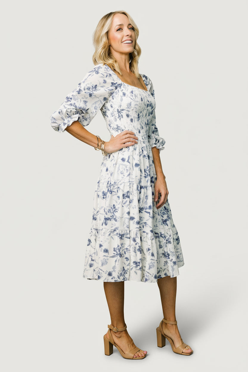 Studio shot of Marta Smocked Midi Dress on a mannequin, highlighting the flowing tiers, smocked waist, and square neckline.