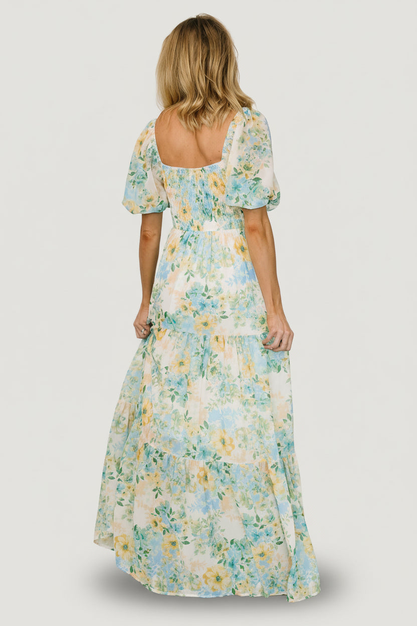 Editorial-style image of Maya Maxi Dress in Garden Multi, emphasizing the flowing chiffon tiers, keyhole detail, and elastic-cuffed sleeves.