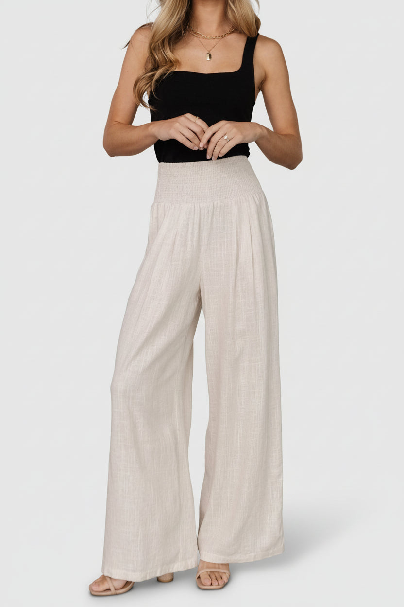 Flat-lay detail of Parvati pants showing fabric weave, natural color, and garment proportions for styling reference.
