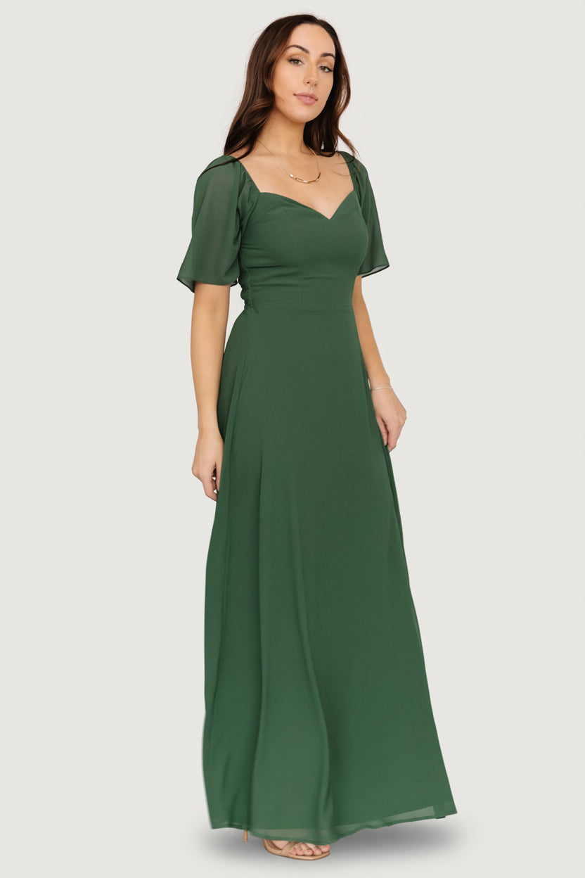 Detail view of Sierra Sweetheart Maxi Dress in evergreen, focused on the fabric drape, hemline, and how the chiffon layers move.