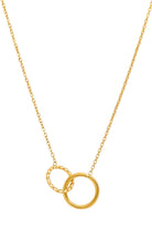 Styled product shot of The Mia Necklace draped on fabric, highlighting the polished and textured interlocking gold circles.