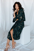 Side view of the ruched midi dress displaying the elastic natural waist, gathering at the waist and the modest front slit.