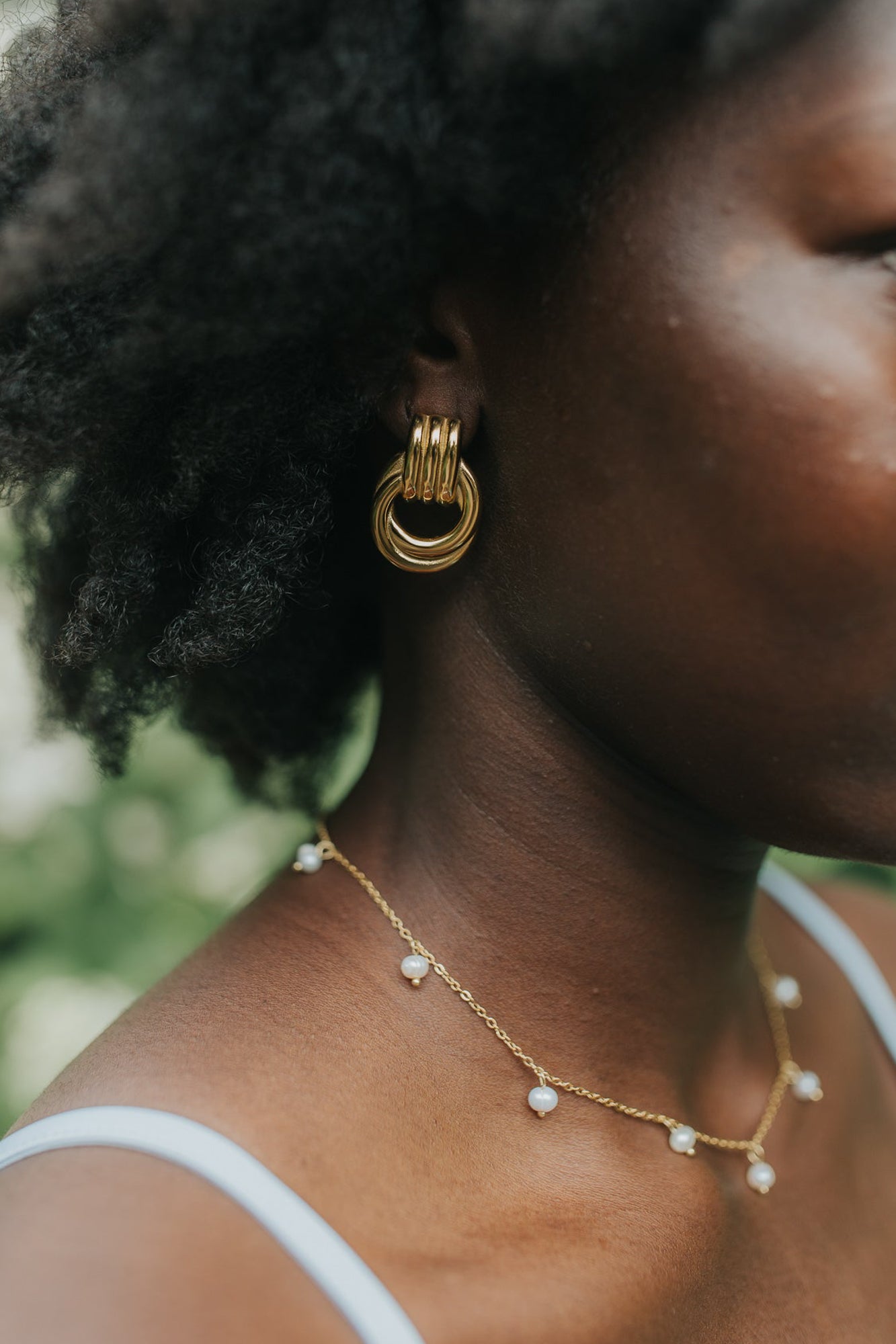 Model wearing The Rosie Pearl Necklace at collarbone length to show drape, pearl spacing, and the necklace's lightweight, feminine profile.