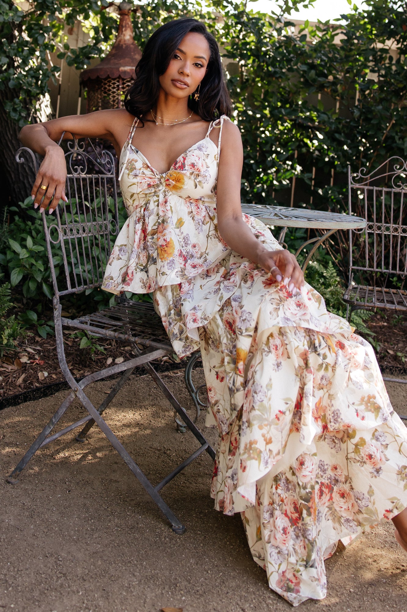 Model walking in the Angelica Tiered Maxi Dress, showing movement of tiers and a flattering, flowy silhouette in a buttercream floral pattern.
