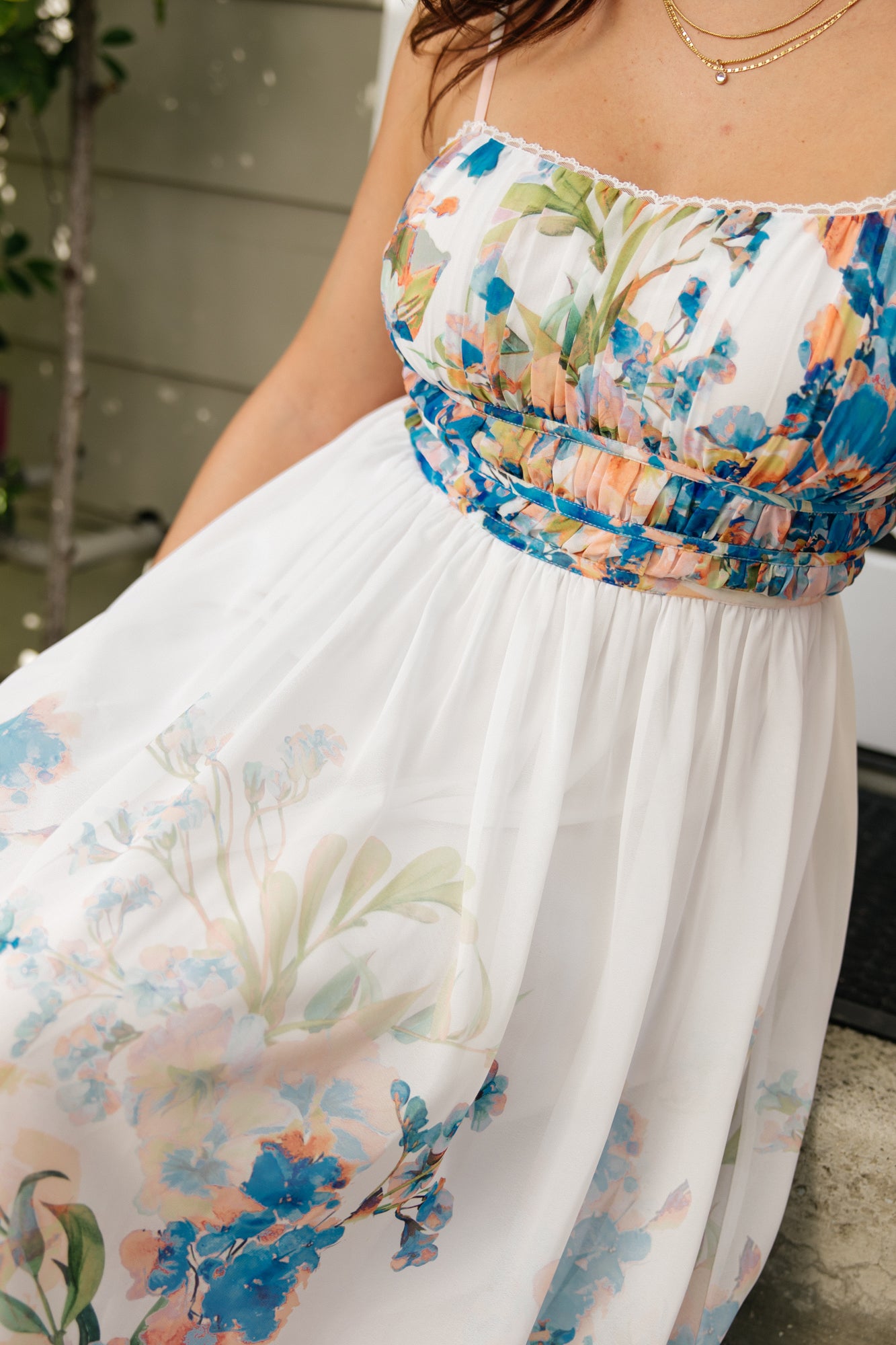 Close-up of the lace-trim V-neck and softly pleated bust of the Marceline chiffon midi dress, showing delicate trim and fabric texture.