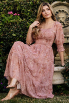 Side-angle view of the Fabian Midi Dress in Mauve + Gold showing puff-style semi-sheer sleeves, smocked ruffle cuffs, and tiered skirt silhouette.