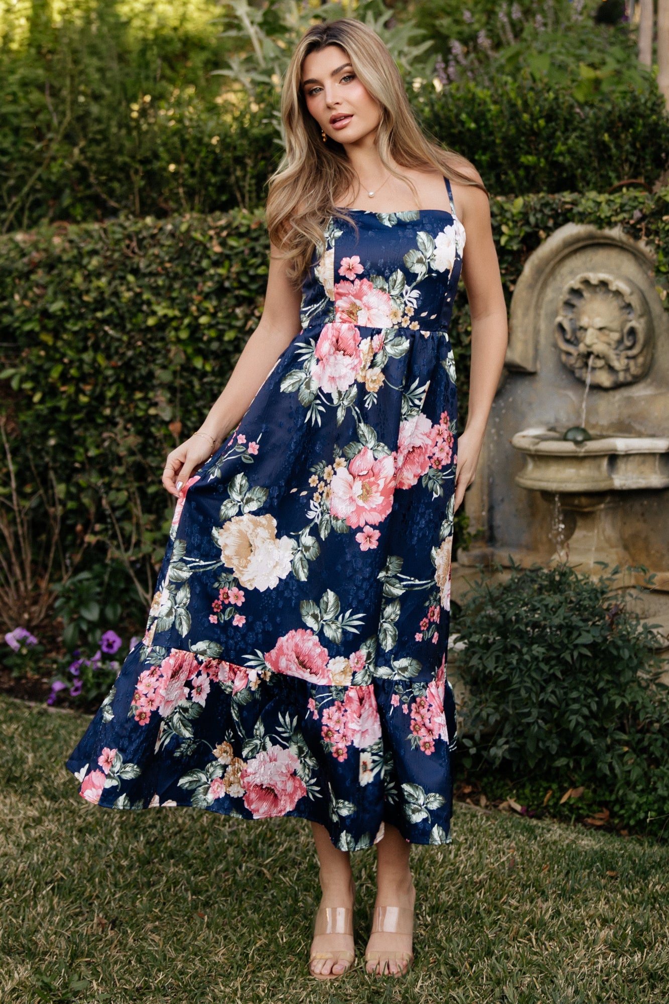 Back view of navy Cherie jacquard dress highlighting smocked back bodice and elasticized waist with adjustable straps.